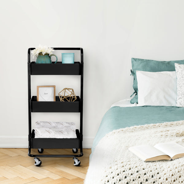 Black cart next to bed