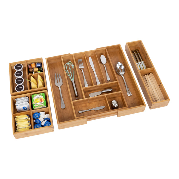 Propped expanded drawer organizer with box sets on white background