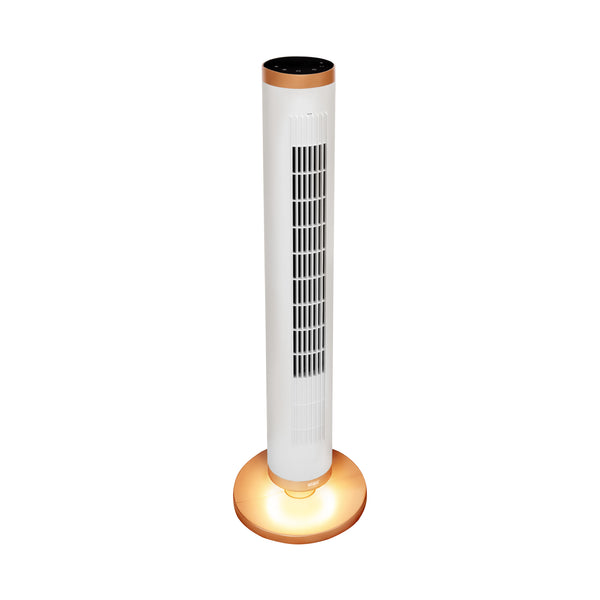 A modern tower fan with a white cylindrical body, black vent grilles, a copper-colored top trim, and a glowing warm light on its circular base, isolated on a white background.
