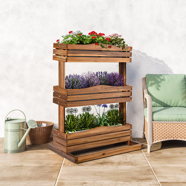 Three-tiered wooden planter with plants on a tiled floor next to a wicker chair.