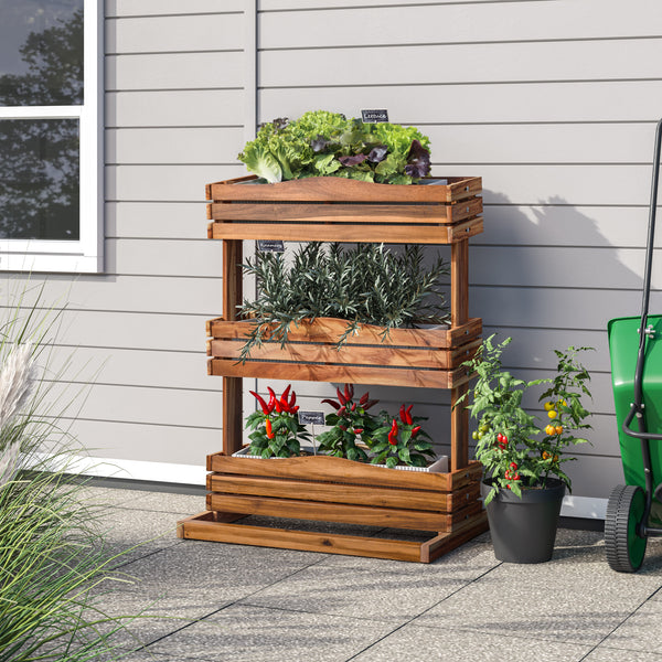 Three-tiered acacia planter with plants on a patio