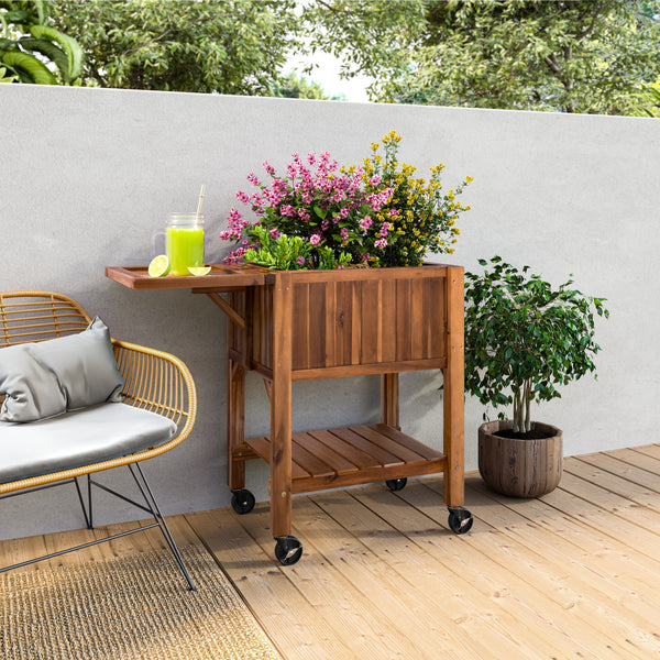 Acacia planter with plants and a chair on a wooden deck.