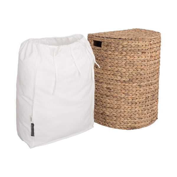 A white drawstring laundry bag standing next to a woven natural fiber cylindrical hamper on a plain white background.