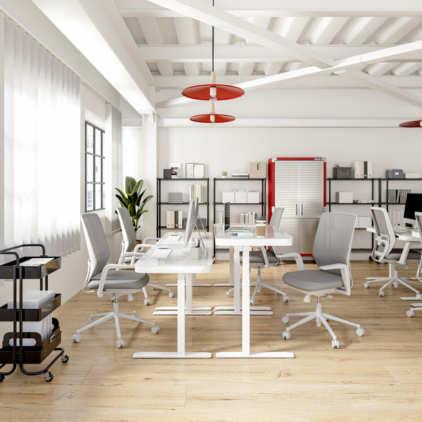 Height adjustable desks in office workspace