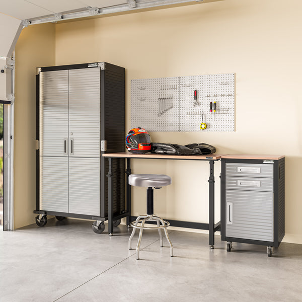 Garage organization system with cabinets, workbench, and tools.