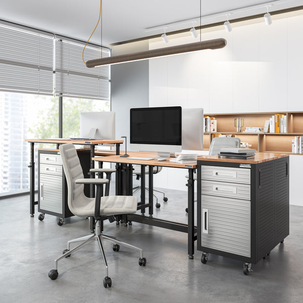 Modern office setup with desks, chairs, and computer monitors in a bright room.