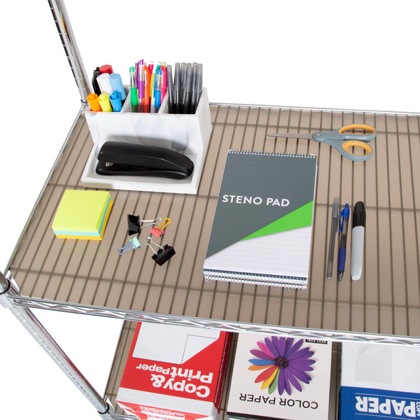 Shelf liner propped with office supplies