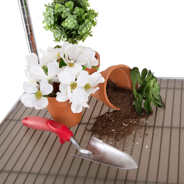 Shelf liner propped with potting supplies