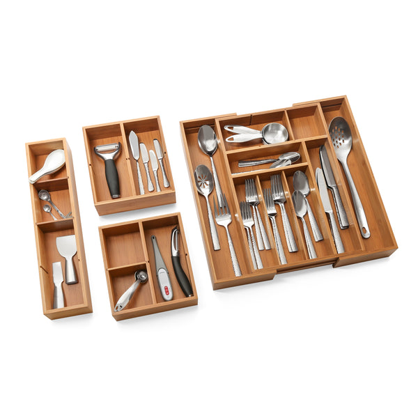 Expanded drawer organizer with box sets propped with utensils